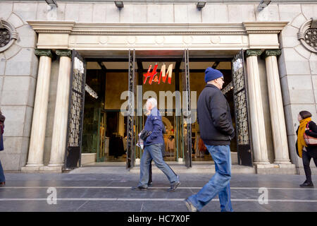 Les gens qui marchent devant H&M entrée dans Gran Via (Madrid, Espagne). Banque D'Images