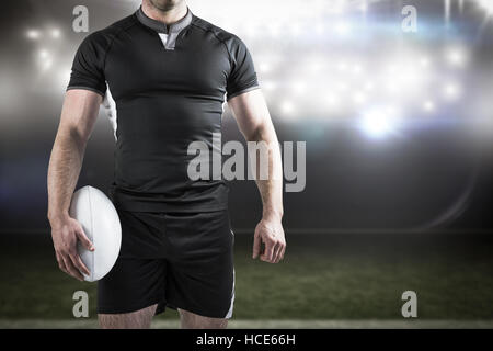 Image composite de difficiles rugby player holding ball Banque D'Images