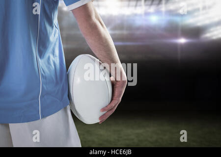 Composite image rugby player with arms crossed Banque D'Images