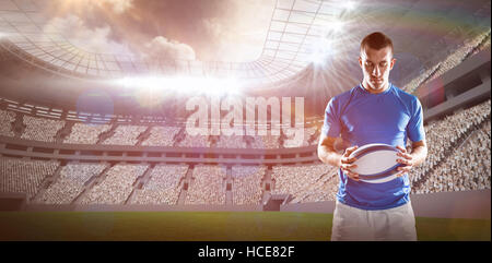 Composite image rugby player holding ball Banque D'Images