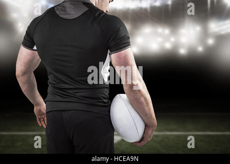 Image composite de difficiles rugby player holding ball Banque D'Images