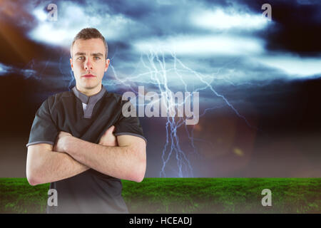 Image composite de froncer rugby player with arms crossed Banque D'Images