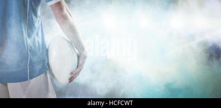 Composite image rugby player with arms crossed Banque D'Images