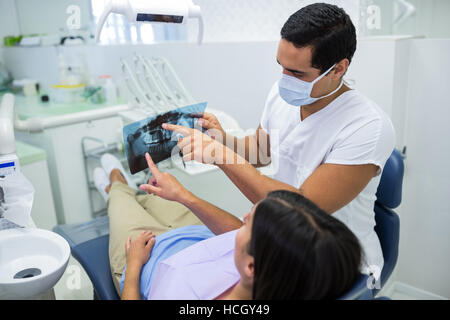 Young male dentist examining X-ray avec la patiente Banque D'Images