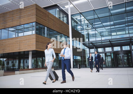 Business people walking outside office building Banque D'Images