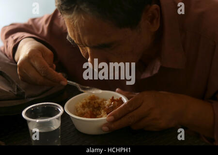 Quezon City, Philippines. 8e Dec 2016. Un homme mange repas gratuit au 'Duterte's Kitchen' dans la ville de Quezon, Philippines, le 8 décembre 2016. La cuisine de 'Duterte', un centre d'alimentation nommé d'après le Président philippin Rodrigo Duterte, offre des repas gratuits aux sans-abri. Le gouvernement des Philippines visant à réduire les taux de pauvreté à entre 13 et 15 pour cent d'ici 2022. © Rouelle Umali/Xinhua/Alamy Live News Banque D'Images