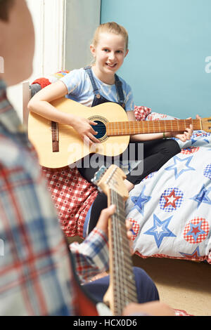 Dans la chambre des enfants jouant ensemble de guitares Banque D'Images