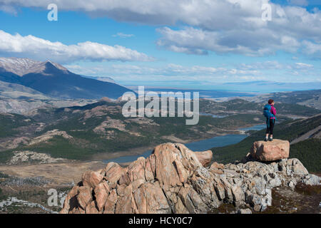 Une femme prend une pause de la randonnée le sentier dans le Parc National El Chalten pour apprécier la vue, le lac se disputaient, Patagonie, Argentine Banque D'Images