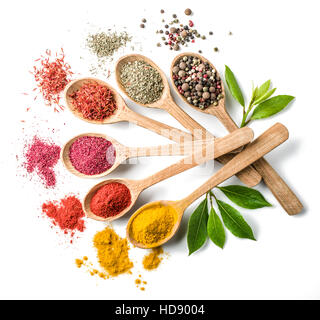 Assortiment d'épices colorées dans l'cuillères en bois sur le fond blanc. Banque D'Images