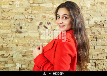 Teenage girl wearing a red jacket smiling Banque D'Images