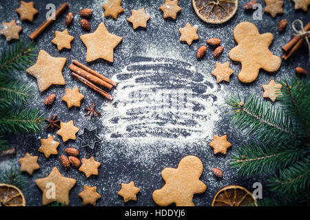 Cadre de Noël avec Gingerbread Man, gingerbread cookies stars, cannelle, épices, amandes et sapin. L'espace de copie pour le texte. Banque D'Images