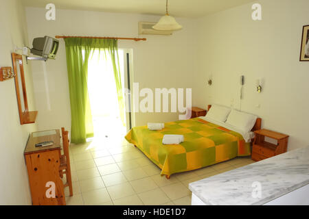Vrahos, Grèce, 10 mai 2013 : l'intérieur de fragments de chambre avec un grand lit et un rideau vert. Banque D'Images