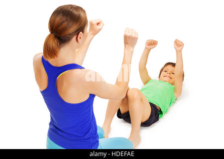 Smiling boy doing exercises with female trainer Banque D'Images