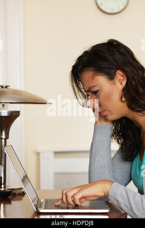 Femme travail à domicile sur son ordinateur portable Banque D'Images