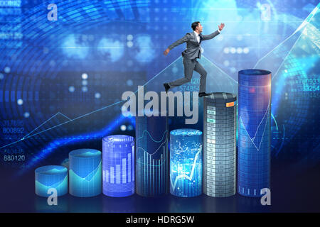 Businessman jumping over bar charts Banque D'Images