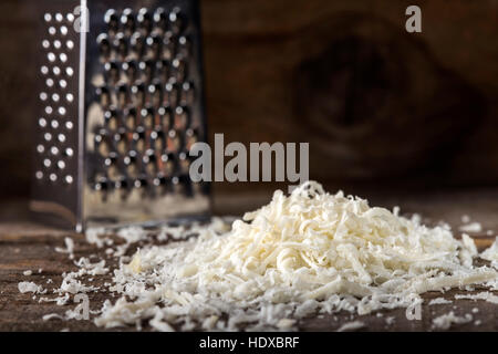 Parmesan fraîchement râpé sur table en bois Banque D'Images