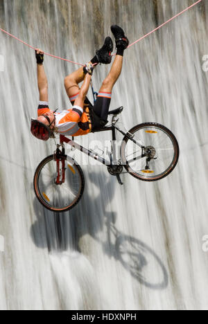 Man crossing une cascade sur une corde avec un vélo, parc national de Kalkalpen, Haute Autriche, Autriche, Europe Banque D'Images