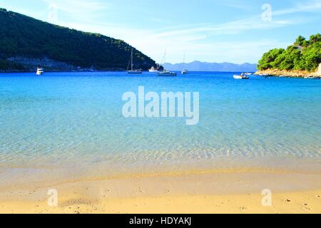 Belle plage de sable et mer bleue avec voiliers dans Prapratno, île de Brac en Croatie Banque D'Images