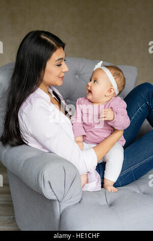 Mère est assis sur un fauteuil avec bébé Banque D'Images