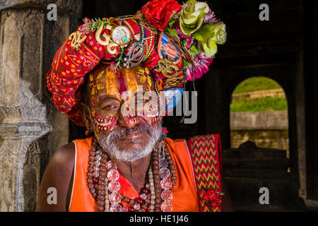 Le portrait d'un sadhu, saint homme, assis à un petit sanctuaire au temple de Pashupatinath sur les rives de la rivière Bagmati Banque D'Images