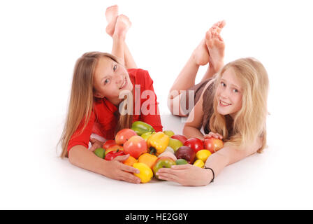 Two girls holding fruits isolated on white Banque D'Images