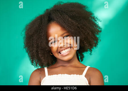 Portrait d'enfants cubains avec les émotions et sentiments. Jeune fille noire de La Havane, Cuba, smiling at camera avec une joyeuse et drôle d'expression. Banque D'Images