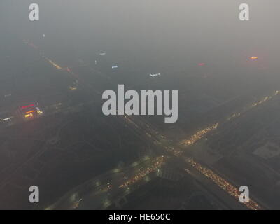 Zhengzh Zhengzh, Chine. Dec 18, 2016. Zhengzhou, Chine 18 décembre 2016 : (usage éditorial uniquement. Chine OUT) .Le smog lourds suaires Zhengzhou, capitale de la province du Henan en Chine centrale, Décembre 18, 2016. Le pire pollution de l'air jusqu'à présent cet hiver commencent à s'installer dans les régions du nord de la Chine, Henan, Shandong, Shanxi, Hebei, Tianjin et Pékin le 16 décembre et devrait durer plus de cinq jours. L'alerte rouge pour la pollution atmosphérique a été émis et les mesures d'urgence ont été prises pour lutter contre le smog. © SIPA Asie/ZUMA/Alamy Fil Live News Banque D'Images