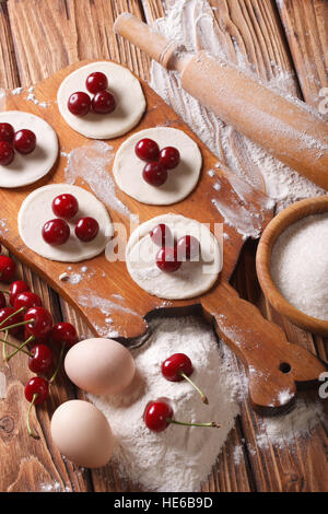 Préparation des boulettes sucrées avec cerises close-up vertical Vue de dessus. Banque D'Images