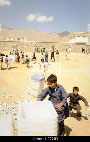 De jeunes Afghans aider à décharger du matériel de scrutin un hélicoptère Mi-17 dans Jaghuri, Afghanistan, le 16 septembre 2010. Les bulletins sont pour le prochain 18 Septembre élections lorsque les Afghans pourront élire la chambre basse du parlement. Banque D'Images