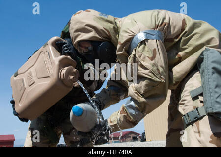 Dans l'US Air Force Explosive Ordnance Disposal aviateurs affecté à la 820e Escadron Cheval Rouge bouchon propre et un produit chimique en fonction de munitions non explosées round lors d'un exercice d'entraînement, le 14 août 2012, à Nellis Air Force Base, Nevada Le cycle chimique a été utilisée pour améliorer les compétences. Navigant de première classe Christopher Tam) Banque D'Images