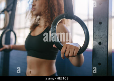 Close up shot of woman exercising on gymnastic rings , avec l'accent sur les mains. Banque D'Images