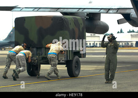 Les aviateurs américains de la 374e Escadre de transport aérien, Yokota Air Base, Japon, charger une remorque cargo sur un C-130 Hercules au cours de l'exécution du moteur de déchargement/sur la concurrence qui est une partie de l'aéromobilité Rodeo 2011, Joint Base Lewis-McChord, dans l'État de Washington, le 25 juillet 2011. L'ORE est un événement destiné à simuler et d'accélérer le déchargement/chargement de dans un environnement de guerre à l'aide d'une équipe de cinq membres. Rodeo est l'US Air Force et du premier ministre d'AMC, les aptitudes au combat international et la concurrence des opérations de vol conçu pour développer et améliorer des techniques, des procédures, et l'interopérabilité, tout en optimisant l'internation Banque D'Images