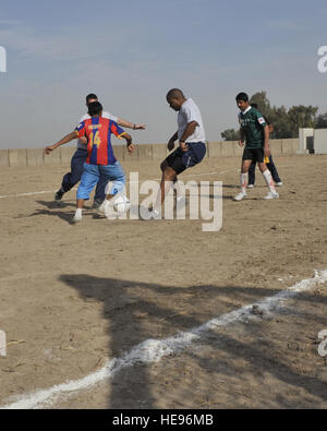 Tech. Le Sgt. Michael Francis, 447e groupe expéditionnaire de la swing shift sous-officier responsable du protocole, utilise son temps de repos pendant le déploiement à Bagdad pour enseigner des compétences de soccer pour les enfants iraquiens et participer à des rencontres avec les soldats iraquiens. Banque D'Images