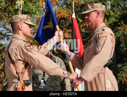 Le colonel Bryan Bartlett (à gauche), 438th Air Expeditionary Vice Commandant de l'Escadre, passe le guidon à nouveau Pohantoon Hawayee-e-commandant le lieutenant-colonel Michael Needham, déployés à partir de la base aérienne d'Andrews, dans le Maryland La cérémonie de passation de commandement a eu lieu à l'aéroport international de Kaboul, Kaboul, Afghanistan, le 11 septembre 2011. Les cadres supérieurs d'un membre de l'Amber Williams) Banque D'Images