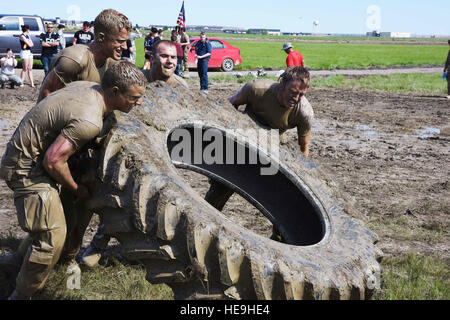 Les membres de l'équipe de la 341Malmstrom Les forces de sécurité les travaux de groupe à l'unisson pour retourner un pneu durant la quatrième édition annuelle de la Conférence des Aces Combat Challenge à la Malmstrom Air Force Base, au Montana, le 5 juin. Au total, 22 stations constitué l'événement pour les membres des forces de sécurité pour terminer devant les juges déterminé l'équipe gagnante. Navigant de première classe Collin Schmidt) Banque D'Images