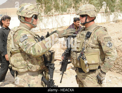 La PROVINCE DE KANDAHAR, Afghanistan -- Le Premier maître de la Marine américaine Jerry Foster (à gauche), l'Équipe de reconstruction provinciale de Kandahar ingénieur de Gulf Port, au Mississippi, des pourparlers avec l'armée américaine Staf Sgt. Bruce Harrington (droite), l'EPR de Kandahar security force squad leader de Buzzards Bay dans le Massachusetts, à propos de la mission au cours de l'évaluation d'un site dans la province de Kandahar le 14 septembre. L'ÉPR fournit des conseils et des ressources pour les propriétaires de l'espace de bataille dans leurs interactions quotidiennes avec le gouvernement du district et aux leaders de l'ensemble de leurs zones d'opération. Airman Senior Sean Martin, l'Équipe de reconstruction provinciale de Kandahar (Libération) Banque D'Images