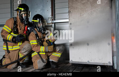 ALTUS AIR FORCE BASE, en Oklahoma - Les pompiers du 97e Escadron de Génie Civil Département incendie pulvériser de l'eau d'un système Ultra Haute pression dans le bâtiment formation incendie lors d'un exercice d'entraînement à la brûlure fosse, 25 avril. Les membres de la 97e SCÉ pompiers formés avec le nouveau véhicule d'intervention rapide de P-34, qui est le plus récent ajout à l'Armée de l'air en cas d'impact de la flotte et le premier véhicule à utiliser la technologie de lutte contre les incendies à ultra haute pression. Le P-36 est non seulement plus rentable, c'est aussi ce qui rend la tâche de lutter contre les incendies plus sûr. Airman principal Kenneth W. Norman) Banque D'Images