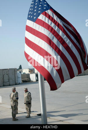 Bagdad, Irak -- Personnel des sergents. Andrew Keller et Jody Nitz et exécuter une Kolnsberg Shannon le lever du drapeau officiel de la cérémonie et le pliage du drapeau des États-Unis à Bagdad, en Irak. La Sather Air Base sur la garde d'honneur soulevées et plié 23 drapeaux des États-Unis. Les sergents Keller et Nitz et Kolnsberg importants sont affectés à la 447e Escadron médical expéditionnaire. Tech. Le Sgt. Cecilio M. Ricardo Jr.) (sortie) Banque D'Images