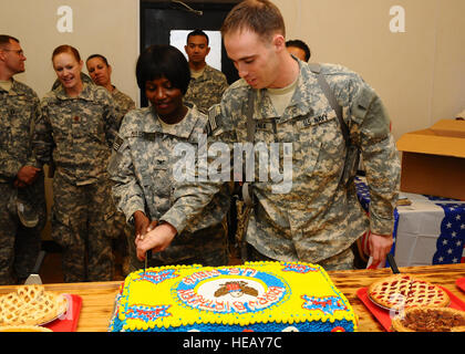 Le Capitaine de vaisseau Sandra Mason et le lieutenant J.G. Jeremy Mazanek Mission-Afghanistan d'entraînement de l'OTAN, l'équipe d'entraînement intégrée médicale, couper le gâteau d'anniversaire de cérémonie pour célébrer la 235e anniversaire de la Marine, le 13 octobre au Camp Mike Spann, Afghanistan. Mason et Mazanek sont tous deux purgé sept mois dans le cadre de déploiements d'une initiative de formation pour encadrer l'Armée nationale afghane 209e de l'Hôpital régional de corps au personnel de mieux répondre aux besoins des patients de l'établissement médical connu seulement en Afghanistan qui fournit des services médicaux à l'ANA, Police nationale afghane, Département National de la sécurité et locaux Banque D'Images