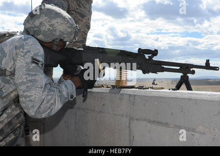 Un membre de la 1re classe Michael Clayton, 5e Escadron des Forces de sécurité Global Strike membre de l'équipe de défi, une mitrailleuse M240 pendant le tournage du concours au Camp Guernesey, Wyo., 23 septembre 2014. Clayton a été assistée par un coéquipier qui a donné des corrections pour la distance et la position des cibles. Stephanie Morris Senior Airman) Banque D'Images