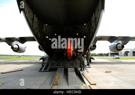 Les aviateurs américains charger un MH-65C hélicoptère Dauphin, affecté à la Garde côtière des États-Unis, de l'escadron tactique d'interdiction de l'hélicoptère sur un C-17 Globemaster III sur la base aérienne de Charleston, S.C., le 3 juillet 2010. Aviateurs mènent contre la drogue et la formation des équipages de missions au cours de cinq jours d'affectations temporaires à El Salvador, Panama, Porto Rico et les États-Unis. (U.S. Air Force photo de Tech. Le Sgt. Dennis J. Henry Jr./libérés) Banque D'Images