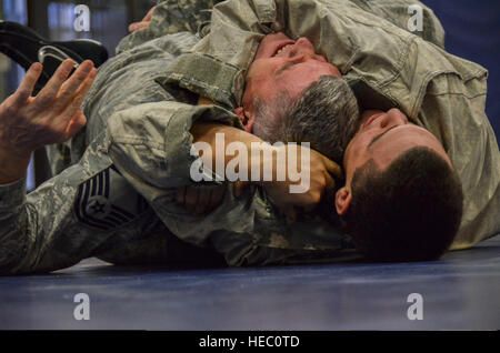 U.S. Air Force d'un membre de la 1re classe Greg Vinueza, bas, tente de dompter le conseiller-maître Sgt. Kevin Wendt au cours de l'Armée moderne Combatives ?s Programme Basic Combatives Niveau 1 16 janvier 2014, à la base aérienne Davis-Monthan Air Force Base, en Arizona (États-Unis Photo de l'Armée de l'air par le sergent. Adam Grant/libérés) Banque D'Images