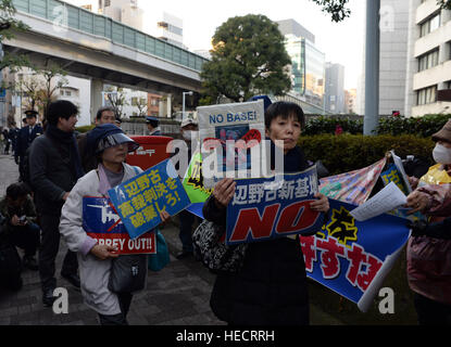 Tokyo, Japon. 18Th Oct, 2016. Les gens tiennent des pancartes contre la décision de la cour supérieure à l'extérieur de l'édifice du Japon à Tokyo, Japon, le 20 décembre 2016. La cour du Japon le mardi a confirmé une décision du tribunal inférieur en faveur de l'intention du gouvernement de transférer une base aérienne du Corps des Marines des États-Unis au sein de la préfecture de l'île d'Okinawa, en dépit du peuple local exige que la base américaine soit déplacé en dehors de la préfecture. © Ma Ping/Xinhua/Alamy Live News Banque D'Images