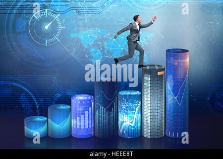 Businessman jumping over bar charts Banque D'Images