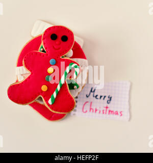 Capture d'un grand angle d'un tas de différents biscuits de Noël sur une surface blanche et un morceau de papier avec le texte joyeux noël handwritt Banque D'Images