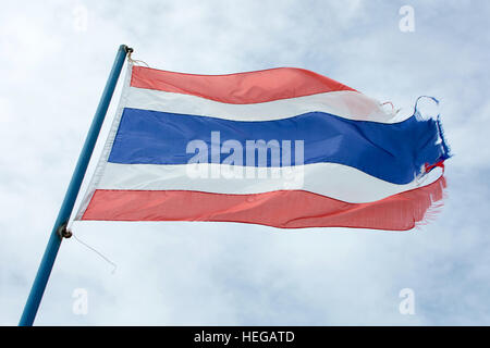 Vieux drapeau onduleux du Royaume de Thaïlande contre le ciel bleu Banque D'Images