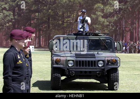 La superstar de la PGA, Tiger Woods, fait une entrée remarquée à bord d'un Humvee de l'armée, lors d'une exposition qu'il a donné à Golf Golf Stryker à Fort Bragg, N.C., 16 avril. Woods a passé une semaine à la poste de l'armée, où l'objet de divers types de formation de l'armée y compris un saut d'un avion. L'exposition fait suite à une clinique de golf spécial qu'il a donnée à des jeunes sélectionnés à Fort Bragg. Les soldats alignés à gauche sont membres de l'armée américaine Golden Knights qui a sauté dans l'événement. photo par K. Kassens TigerWoodsFortBragg2004 Banque D'Images