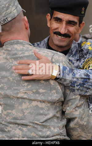 Le colonel de l'armée américaine John Hort (à gauche), commandant de la 3e Brigade Combat Team, 4e Division d'infanterie, est adoptée par le brigadier de la police nationale irakienne. Le général Ali Ibraheem Dabown, commandant de la 8e Brigade, 2ème Division, après une cérémonie pour marquer la transition de l'autorité de l'équipe de combat de la 3e Brigade, 4e Division d'infanterie, à la 3e Brigade Combat Team, 82e Division aéroportée, à la base d'opérations avancée de loyauté, dans Muhallah Beladiyat, 732, l'est de Bagdad, Irak, le 14 février. L'Autorité de transition 153028 Cérémonie Banque D'Images