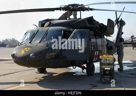 Une évacuation sanitaire de l'équipage de l'entreprise C, 2e Bataillon, 227e Régiment d'aviation, 1st Air Cavalry Brigade, Division de cavalerie, effectuer la maintenance d'un UH-60 Black Hawk medevac, ici, 2 décembre. Les hélicoptères d'évacuation médicale dans le 1er PBR ne battent pas beaucoup ce déploiement comme soldats ne sont pas aussi souvent gravement blessés, a déclaré le Capitaine Alec Finlay, un pilote d'évacuation sanitaire et d'officier responsable de l'unité d'évacuation sanitaire de Taji. Cav Air medevac, Surge, rabattement 228908 Banque D'Images