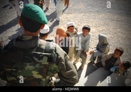 Soldat de l'Armée nationale afghane regarde les enfants avant qu'ils sont vus par le médecin à la clinique médicale, Camp Clark, Khowst Province, Afghanistan, le 22 décembre. La clinique apporte son soutien à des enfants afghans dans la région de fournir des vitamines et de vêtements d'hiver. L'aide humanitaire 243980 Banque D'Images